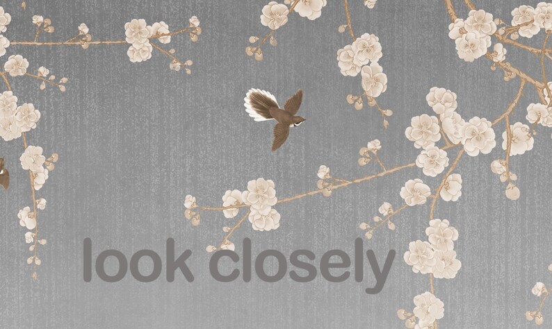 May include: A gray background with a delicate pattern of white flowers and branches. The text "look closely" is printed in the center of the image. A small brown bird with a long tail is flying in the upper left corner.