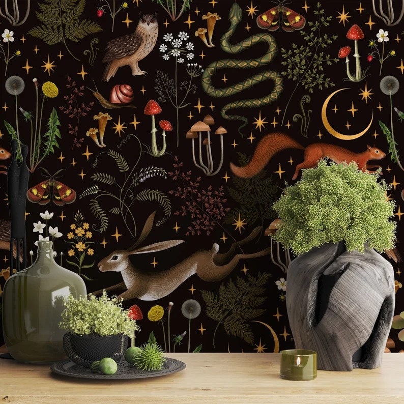 May include: A dark background with a repeating pattern of woodland creatures, plants, and stars. The pattern includes a snake, a rabbit, a squirrel, a mushroom, a fern, a dandelion, a moth, and a crescent moon. The pattern is in shades of brown, green, yellow, and white.