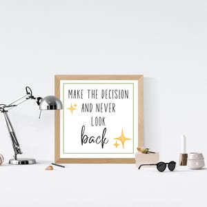 May include: A framed print with a white background and green border. The print features the text "Make the decision and never look back" in black with yellow stars.
