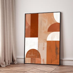 Op de afbeelding: Abstracte kunstprint in een zwarte lijst. Het kunstwerk toont geometrische vormen in bruin, wit en beige tinten. Het ontwerp omvat rechthoeken, vierkanten en halve cirkels, wat een moderne en minimalistische uitstraling creëert. De print wordt tegen een neutrale muur getoond.