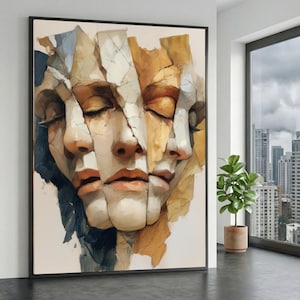 May include: Abstract art print featuring a fragmented face with closed eyes. The artwork uses a palette of beige, brown, and blue tones, creating a layered effect. The piece is framed in black and hangs on a white wall.