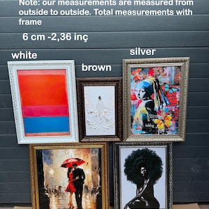 a display of framed art on a table
