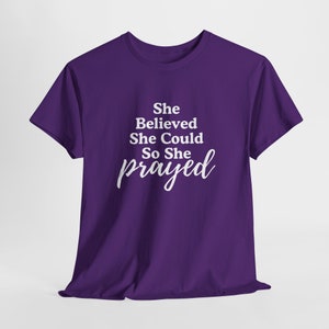 May include: Purple t-shirt with white text that reads "She Believed She Could So She prayed".