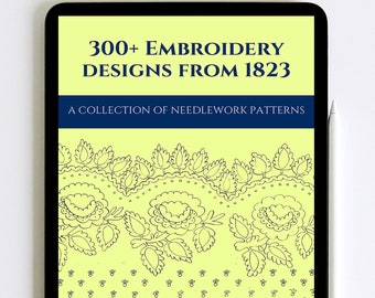 May include: A digital tablet displaying a book cover with the title "300+ Embroidery Designs from 1823" and the subtitle "A collection of needlework patterns". The cover features a yellow background with a black and white floral design.