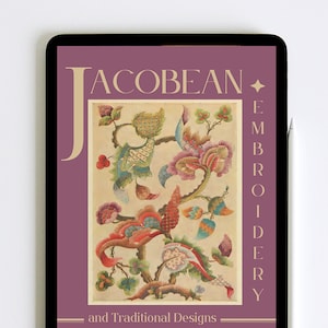 May include: A digital tablet displaying a book cover with a purple background and a floral design. The title of the book is "Jacobean Embroidery and Traditional Designs".