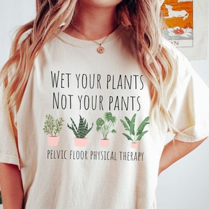 May include: A white t-shirt with the text "Wet your plants not your pants" and a row of five potted plants. Below the plants is the text "Pelvic Floor Physical Therapy".