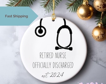 May include: White ceramic Christmas bauble featuring a black stethoscope and the text "Retired Nurse Officially Discharged est 2024".