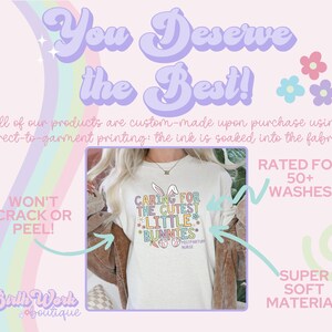 May include: A white long-sleeved t-shirt with a colorful graphic that says "Caring for the Cutest Little Bunnies" and "Postpartum Nurse". The shirt is on a pink and white background with the text "You Deserve the Best!" and "Won't Crack or Peel!"