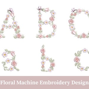 Può includere: Design di ricamo a macchina floreale con le lettere maiuscole e minuscole A, B e C. Le lettere sono decorate con rose rosa, piccoli fiori bianchi e foglie verdi. Il design include un accento a farfalla su alcune lettere.