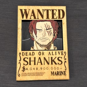 Pode incluir: Um cartaz de procurado de madeira com uma imagem de desenho animado de Shanks, um personagem do anime One Piece. O cartaz &eacute; marrom com detalhes em vermelho e preto. O texto no cartaz diz "WANTED", "DEAD OR ALIVE", "SHANKS", "$4.048.900.000", e "MARINE".