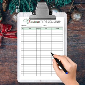 May include: A white clipboard with a green and red Christmas themed sign up sheet for a talent show. The sign up sheet has columns for number, name, number in group, talent, and contact.