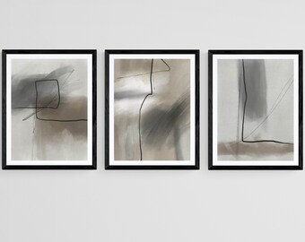 May include: Set of three abstract art prints in black frames. Each print features a different abstract design in shades of gray and brown with black lines.