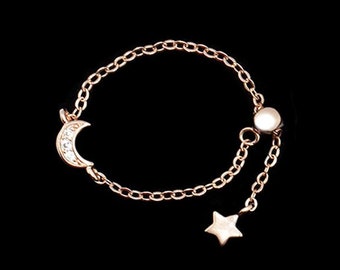 Adjustable sterling silver chain ring with rose gold plating and cubic zirconia with moon and small star pendant