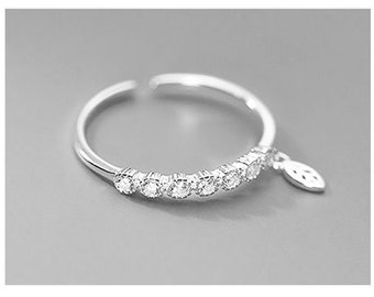 Adjustable 925 sterling silver ring with cubic zirconia and a small dangling leaf