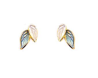 May include: A pair of gold-toned earrings with a leaf design. The leaves are layered and have a blue and white enamel finish.