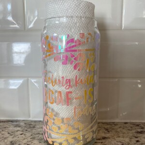 May include: A clear glass jar with a white paper towel inside. The jar has a pink, orange, and yellow design with the text "Feeling kinda DGAF-ish today".