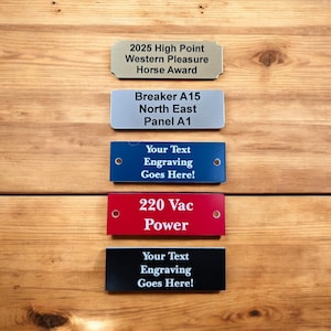 May include: Five rectangular metal plaques with engraved text. The top plaque is gold and reads "2025 High Point Western Pleasure Horse Award". The second plaque is silver and reads "Breaker A15 North East Panel A1". The third plaque is blue and reads "Your Text Engraving Goes Here!". The fourth plaque is red and reads "220 Vac Power". The bottom plaque is black and reads "Your Text Engraving Goes Here!".