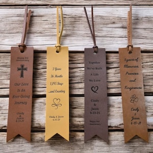 May include: Four brown leather bookmarks with different engraved designs and text. The bookmarks feature a cross, hearts, and the text "Happy 3rd Anniversary", "3 Years 36 Months 1,095 Days and Counting", "Together We've Built A Life We Love", and "3 years of Memories. Promises and Forgiveness".