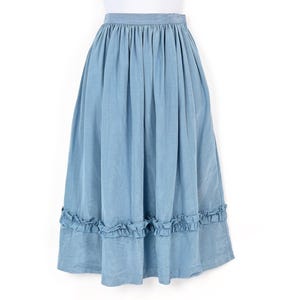 May include: A pale blue midi skirt featuring a gathered waist and a frilled hem. The skirt is crafted from a soft, flowing material and is presented on a white mannequin. This skirt is a versatile item for both casual and semi-formal outfits.
