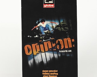 May include: Black box with the word "Opinion" in orange and white text. The box features a skateboarder mid-air and the Globe logo. The names of skateboarders are listed below the title.
