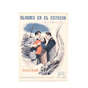 May include: Vintage book cover titled "ALARMA EN EL EXPRESO" featuring a dramatic illustration. The cover depicts three people, a train, and a snowy landscape. The book is from "EDICIONES BIBLIOTECA FILMS" and "Editorial Atlas."