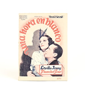 May include: Vintage movie poster for "Una Hora en Blanco" featuring Loretta Young and Franchot Tone. The poster has a cream background with red and black text, and a clock design. The actors are in the foreground.