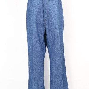 May include: Light blue denim trousers with a flared leg. The trousers feature a classic five-pocket design and a button and zip closure. The denim fabric has a medium wash and a slight sheen. The trousers are displayed on a mannequin.