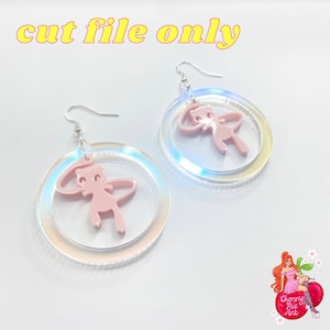 May include: A pair of pink acrylic earrings. Each earring has a pink cartoon figure inside a clear, iridescent circle, with silver hooks. The text "cut file only" is in yellow letters at the top. The earrings are on a white background.