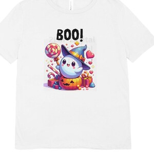 May include: White t-shirt with a cute cartoon ghost wearing a witch hat and holding a lollipop. The ghost is sitting on a pumpkin and surrounded by candy and hearts. The text "BOO!" is printed on the shirt.