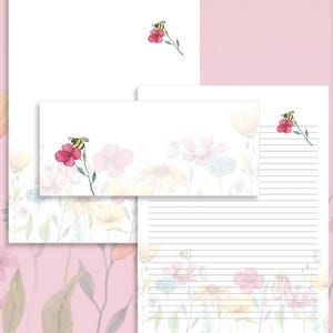 May include: Stationery set featuring a watercolor floral design with bees and flowers in shades of pink, yellow, and blue. The set includes lined and unlined paper, and an envelope. The stationery is perfect for writing letters or notes.
