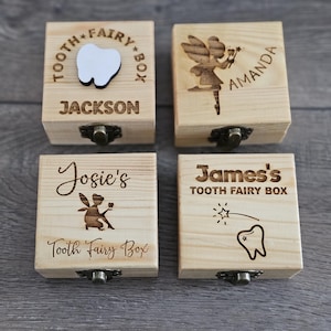 May include: Four wooden tooth fairy boxes with personalized names and designs. The boxes are made of light brown wood and have a small metal latch. The designs include a tooth, a fairy, and the words "Tooth Fairy Box".