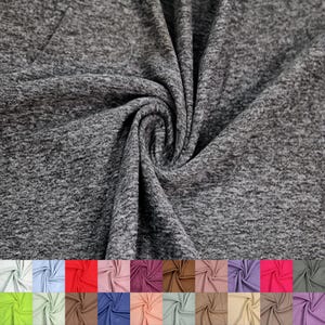 May include: Close-up of a grey melange fabric with a soft, textured appearance. The fabric is draped, showing folds and shadows. A colour palette of various fabric swatches is displayed at the bottom of the image.