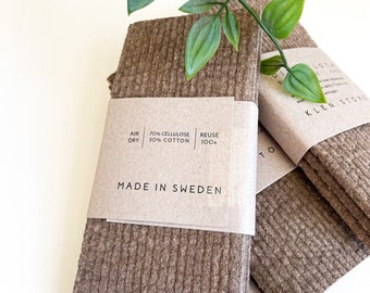 May include: A stack of brown cellulose cleaning cloths with the text "AIR DRY 70% CELLULOSE 30% COTTON REUSE 100x MADE IN SWEDEN" on the packaging.
