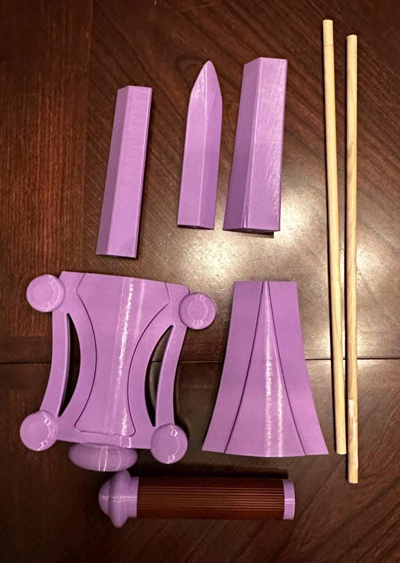 May include: A set of purple 3D printed pieces for a model of a sword, along with two wooden dowels.