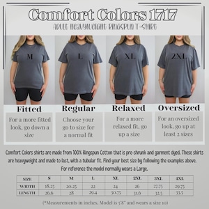 May include: Image of Comfort Colors 1717 adult heavyweight ringspun t-shirts. The image shows four models wearing different sizes: M, L, XL, and 2XL. The text provides sizing guidance, including width and length measurements in inches.