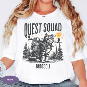 Quirky fantasy reader Comfort Colors apparel
Ridoc inspired funny fantasy themed t-shirt
Book lover broccoli cat graphic shirt
Dragon rider inspired humorous fantasy tee
Cute fantasy cat shirt for romantasy fans
Vintage style Quest Squad broccoli cat tee