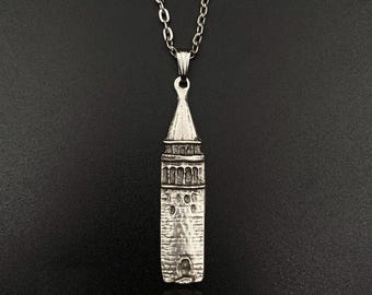 Op de afbeelding: Zilveren ketting met een gedetailleerde hanger in de vorm van de Galata-toren in Istanbul, Turkije.