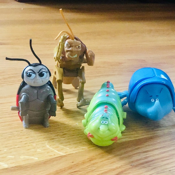 A set of four vintage McDonald’s / A Bug’s Life Wind up toys
