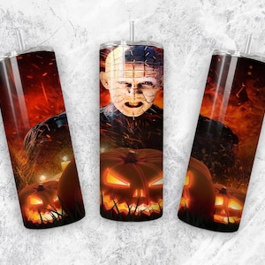 May include: Three stainless steel tumblers with a Halloween theme. The tumblers feature a scary character with a pumpkin and flames in the background.