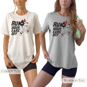May include: Two short-sleeved crew neck t-shirts, one in cream and one in light gray, each featuring a black graphic of a cartoon mouse running and the text "RUN YOUR EARS OFF" in a bold, blocky font. The shirts have a standard fit.
