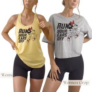May include: A yellow tank top and a grey cropped t-shirt, both featuring a graphic of Minnie Mouse running and the black text "RUN YOUR EARS OFF". The garments are paired with black athletic shorts, showcasing a casual athletic style for active wear.