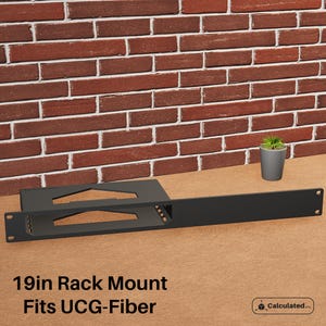 May include: A black metal 19-inch rack mount for a fibre optic device. The rack mount has a cutout for the device and a long, flat section for mounting. The text "Fits UCG-Fiber" is printed below the rack mount.