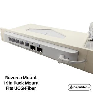 May include: White 19-inch rack mountable device with multiple ports and a power cord. Reverse Mount. Fits UCG-Fiber. Calculated Mfg.