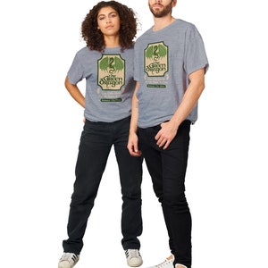 May include: Two people wearing grey t-shirts with a green dragon graphic and the text "The Green Dragon" and "The Only Brew For The Brave & Bold".