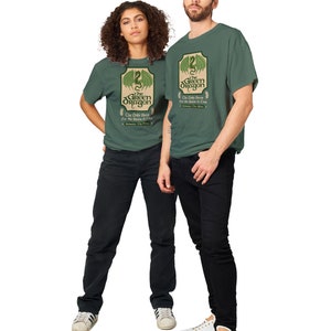 May include: Two people wearing green t-shirts with a green dragon graphic and the text "The Green Dragon" and "The Only Brew for the Brave & True".