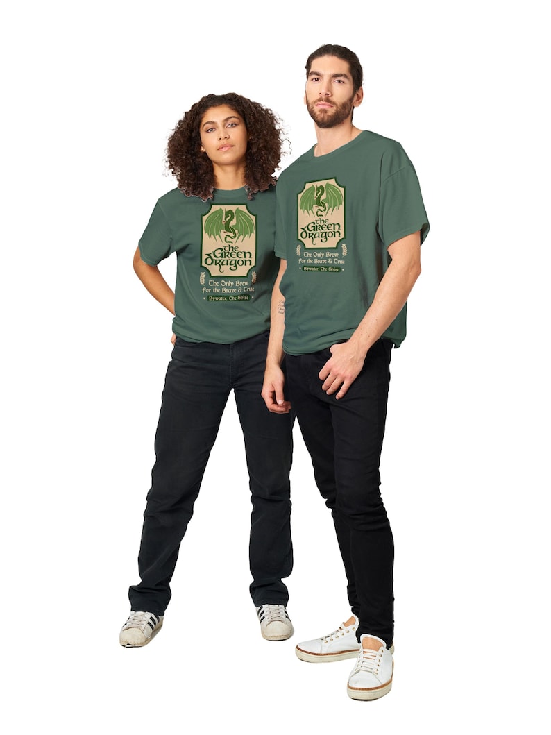 May include: Two people wearing green t-shirts with a green dragon graphic and the text "The Green Dragon" and "The Only Brew for the Brave & True".