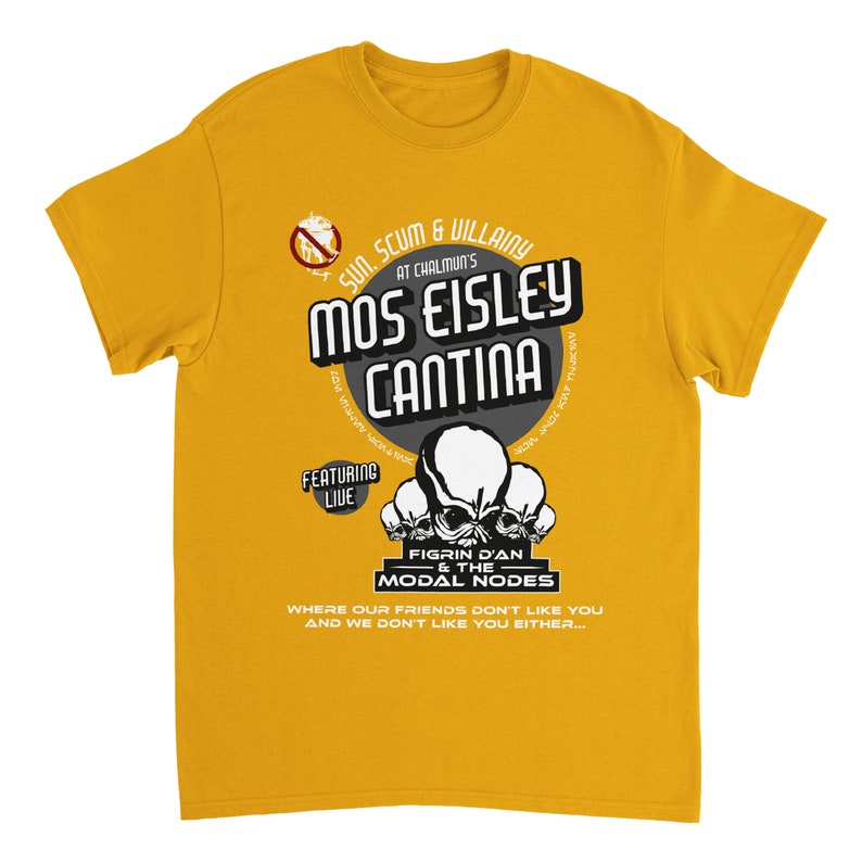 May include: Mustard yellow t-shirt with a graphic design. The design features the text "Mos Eisley Cantina" in a stylized font, along with the words "Sun, Scum & Villainy" and "Figrin D'an & The Modal Nodes". The shirt also includes the phrase "Where our friends don't like you and we don't like you either..."