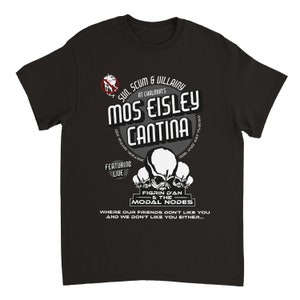 May include: Black t-shirt with a graphic design featuring the text "Mos Eisley Cantina" and "Figrin D'an & the Modal Nodes." The design includes skull-like figures and the phrase "Where our friends don't like you and we don't like you either..."