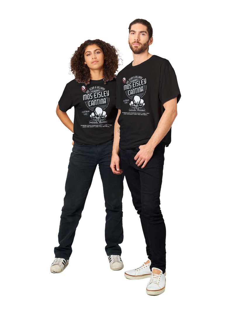 May include: Two people wearing black t-shirts and black jeans stand side by side. The t-shirts feature the text "Mos Eisley Cantina" with a graphic design. The woman wears white sneakers, and the man wears white sneakers.
