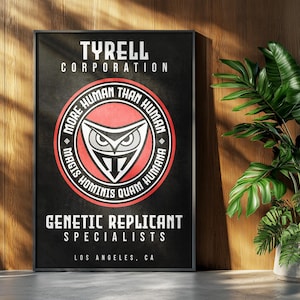 May include: Black framed poster with the text "TYRELL CORPORATION" and "MORE HUMAN THAN HUMAN". The poster also reads "GENETIC REPLICANT SPECIALISTS" and "LOS ANGELES, CA". A plant in a grey pot is to the right.